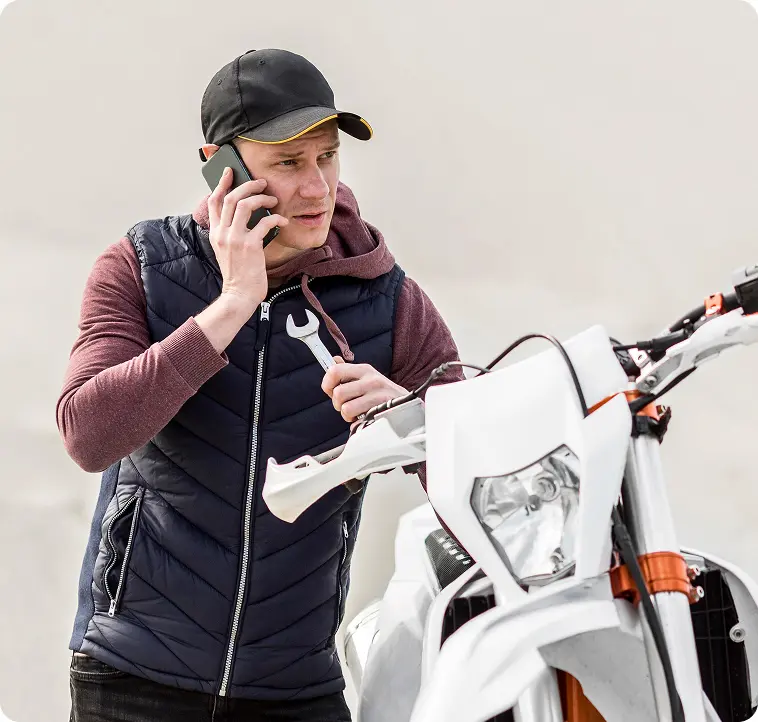 Man calling for help with motorbike repair